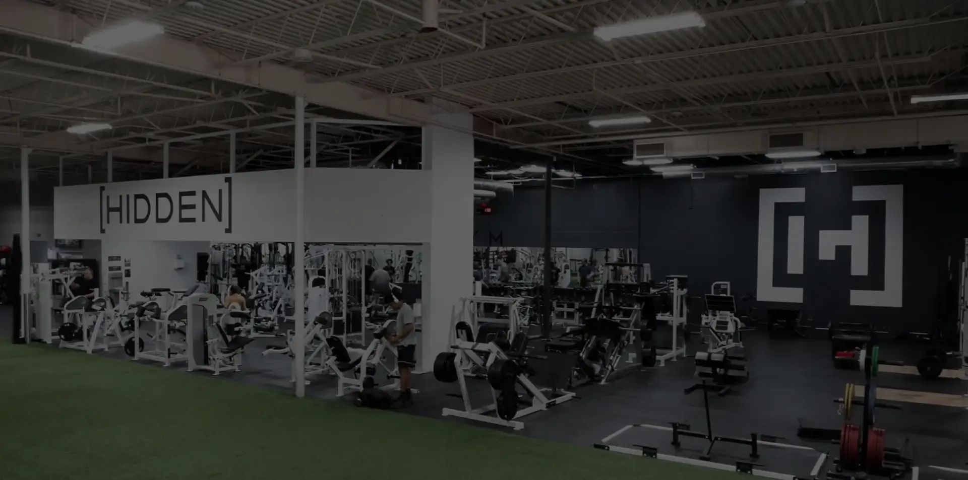 HYROX training group flexing together at Hidden Gym Allen