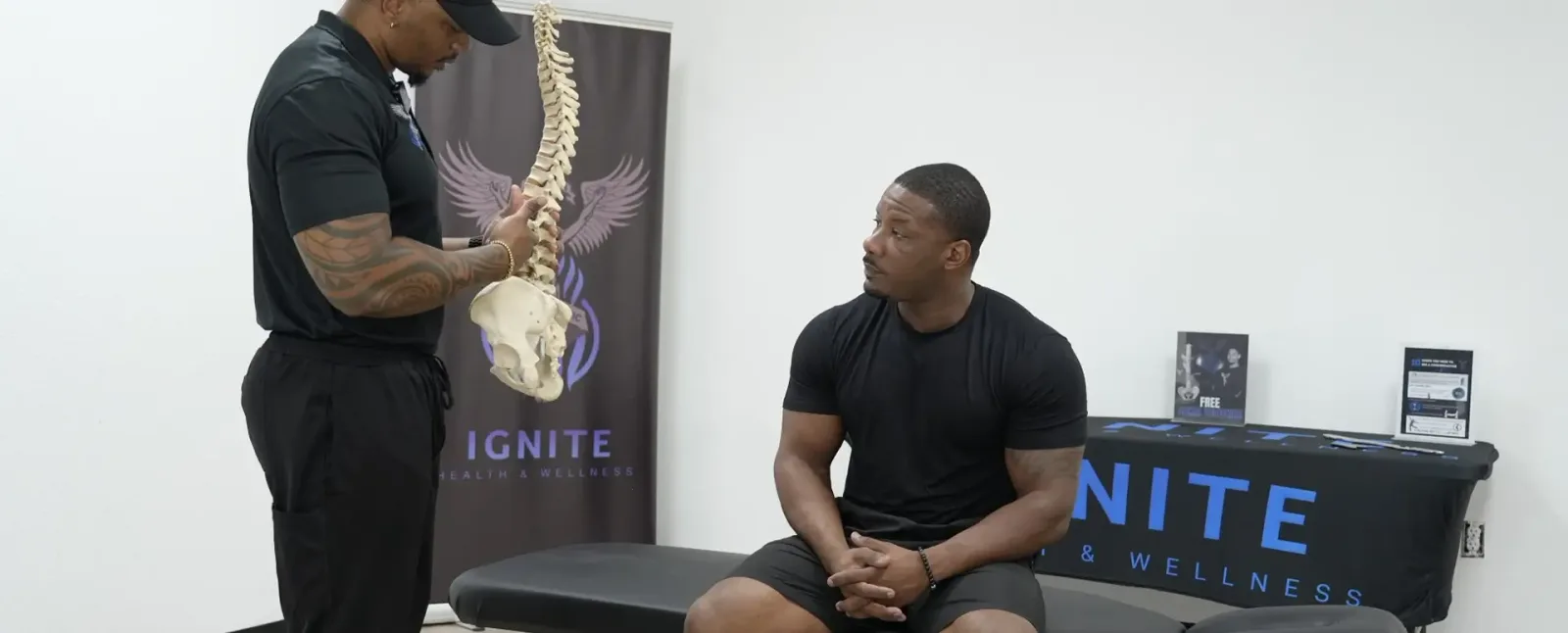 Chiropractor educating a client at Ignite inside Hidden Gym
